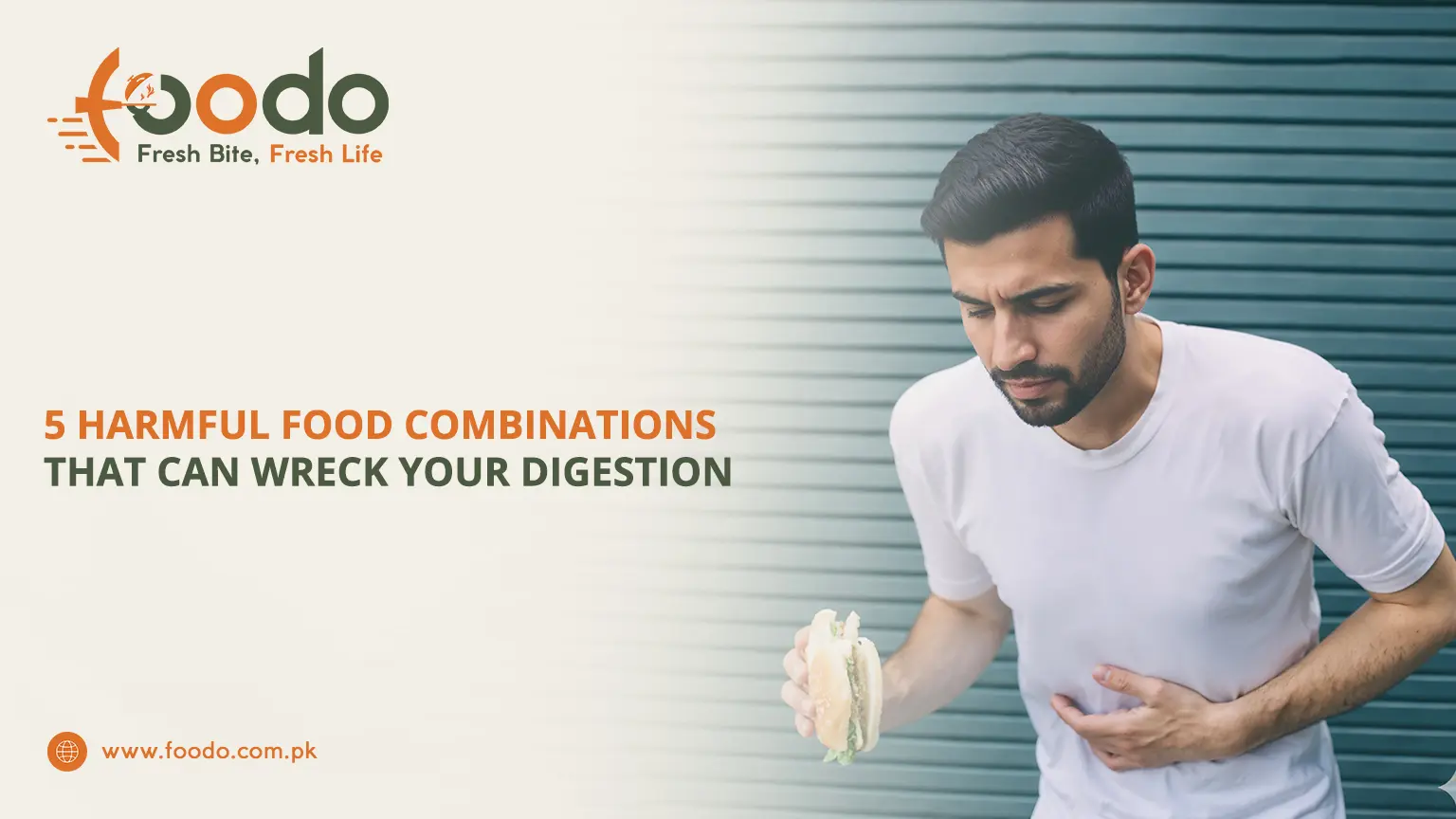 Bearded young man in white t-shirt holding sandwich and clutching stomach in pain, showing discomfort from harmful food combinations that wreck digestion